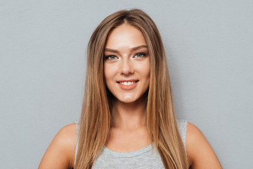 Naklejka premium Close up portrait of casual smiling girl looking at camera