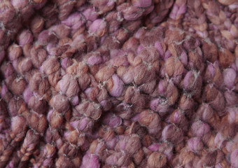 A full page of pink bobbly knitted fabric background texture