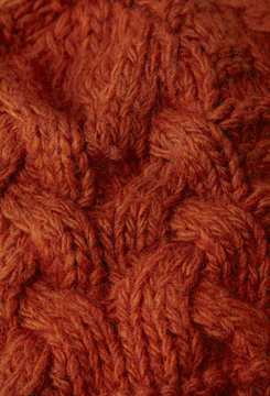 A full page of brick red chunky knit background texture