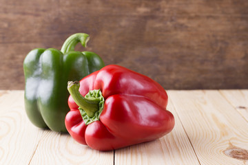 Fresh sweet peppers red and  green on wooden background
