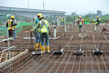 Construction workers fabricating floor slab reinforcement bar at the construction site in Malacca,...