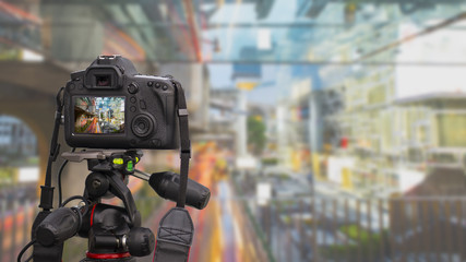 Closeup of a camera on a tripod outdoors taking photo of citysca