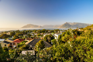 Fototapeta na wymiar Beautiful evening view of the residential area of Kommetjie, a small town near Cape Town in the Western Cape province of South Africa. In the background you can see Hout bay and Chapman's peak drive.