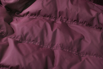 A full page of burgundy red sleeping bag background texture