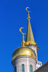 Fototapeta na wymiar Gilded dome and spire Muslim mosque
