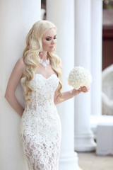 Beautiful Bride Portrait holding wedding bouquet posing in lace