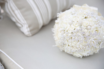 close up of wedding bouquet with brooches