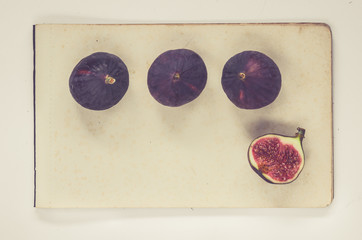 figs lying on sheets of vintage paper - natural history book style 