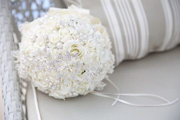 close up of wedding bouquet with brooches