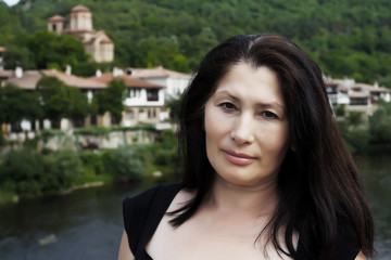 Middle-aged woman on the background of the old town