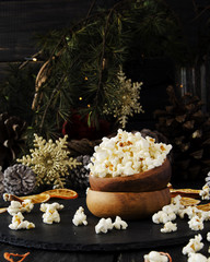 popcorn in a wooden plate on the background of Christmas