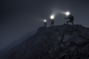 Lightbeams in the darkness on mountain ridge