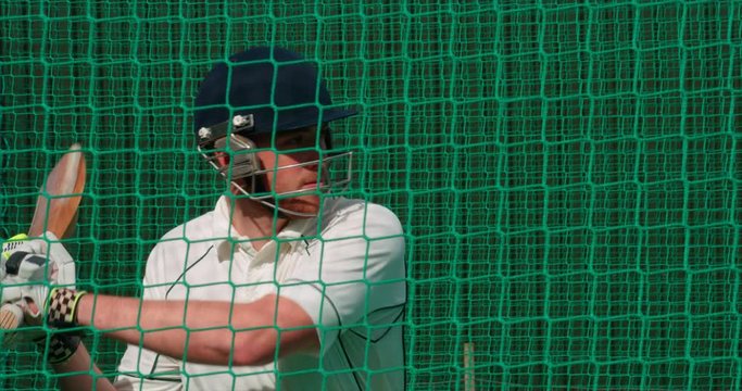 Cricketer hits cricket ball towards camera