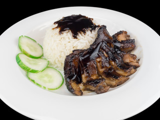 Grilled chicken teriyaki with rice and vegetables on a white plate isolated on the black background with clipping path