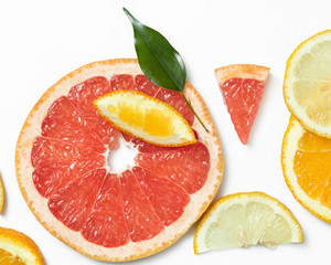 Naklejka na ściany i meble Fresh citrus fruits slices background viewed from above.