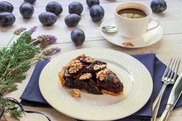Piece of plum cake with coffee.