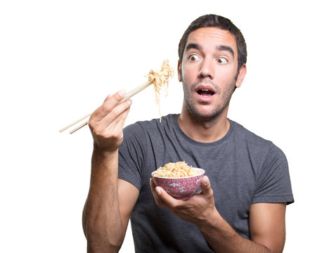 Surprised Young Man Eating Noodles