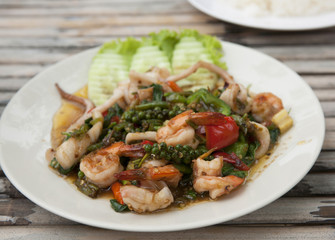 Colorful Thailand seafood salad with freshly-caught seafood and vegetables made at authentic Thai seafood restaurant on Koh Samet island in the Gulf of Thailand.