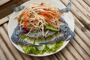 Colorful Thailand seafood salad with freshly-caught seafood and vegetables made at authentic Thai seafood restaurant on Koh Samet island in the Gulf of Thailand.