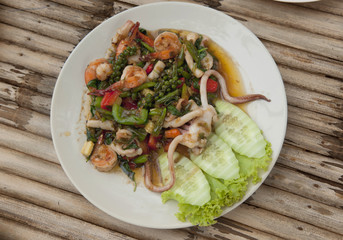 Colorful Thailand seafood salad with freshly-caught seafood and vegetables made at authentic Thai seafood restaurant on Koh Samet island in the Gulf of Thailand.