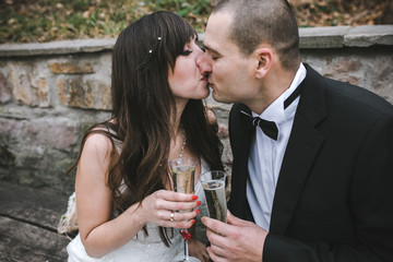 Beautiful wedding couple drinking champagne