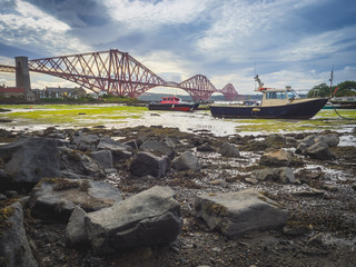 Boat moored in front of the Forth Rail Bridge