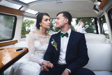 bride and groom sitting in the car