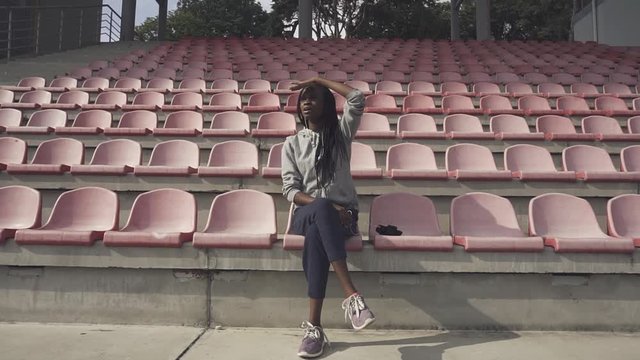 Young beautiful woman looking at some sport and admire the result