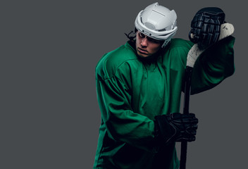 Hockey player holds gaming stick.