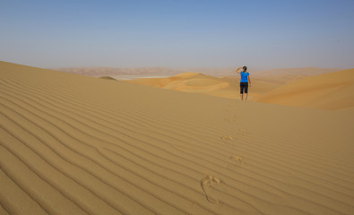 Fototapeta na wymiar Woman walking in a desert