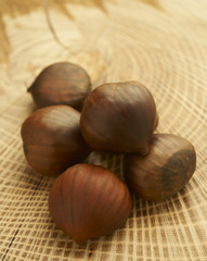 Natural Chestnuts Piled on Wooden Surface