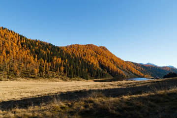 Fototapeta premium Reflections on water, autumn panorama from mountain lake