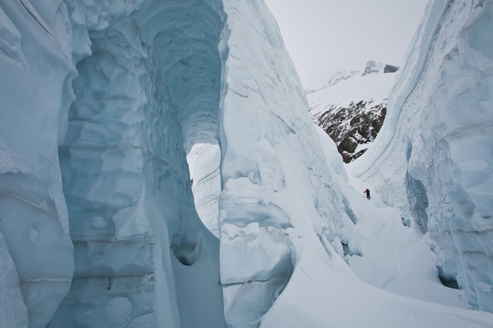 A male backcountry skier weaves his way up a heaily crevassed glacier. Icefall Lodge, Golden, British Columbia, Canada