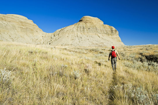 A hiker in the Killdeer Badlands, East Block, Grasslands National Park, Saskatchewan, Canada