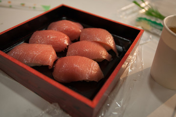 Fresh pink of raw Otoro Nigiri Sushi of Blue fin Tuna on a square box ready to eat