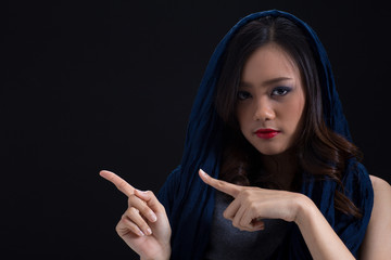 Mysterious girl presenting blank right side wearing red lipstick with blue fabric cover her head...