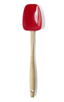 A red silicone and wooden spatula isolated on a white background