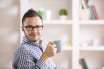 Male drinking coffee at workplace