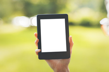 Female hand holding white tablet