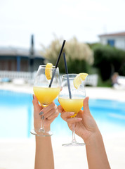 Woman hands with glasses with cocktails