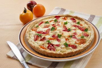 Tart with salted sheep cheese and tomatoes
