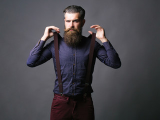 Trendy man pulls suspenders