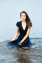 young sexy woman sitting in water