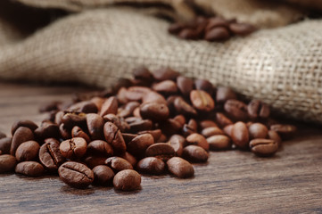 closeup coffee beans on wooden desk. vintage picture