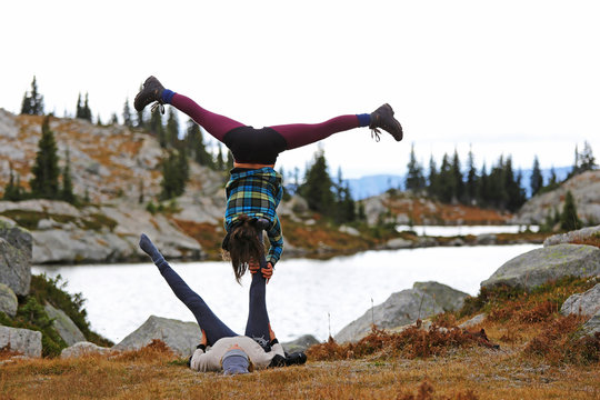 Man and woman practicing acroyoga in the park