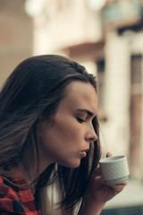 Pretty girl drinks coffee