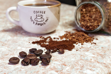 cup of coffee and coffee-beans on the kitchen table