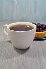 Hot black tea in a white cup
