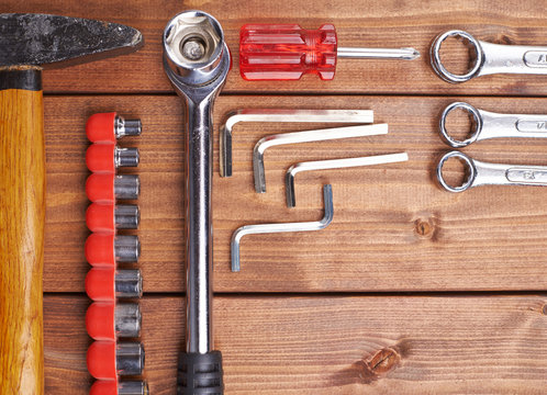 Set of different work tools on wooden surface