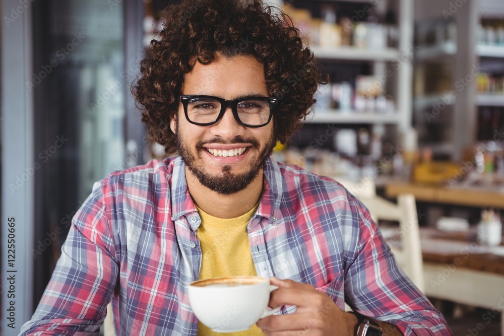 Poster portrait of man smiling while having coffee
